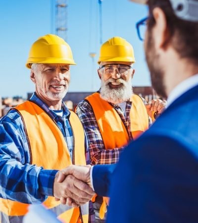 construction-worker-in-protective-uniform-shaking-min